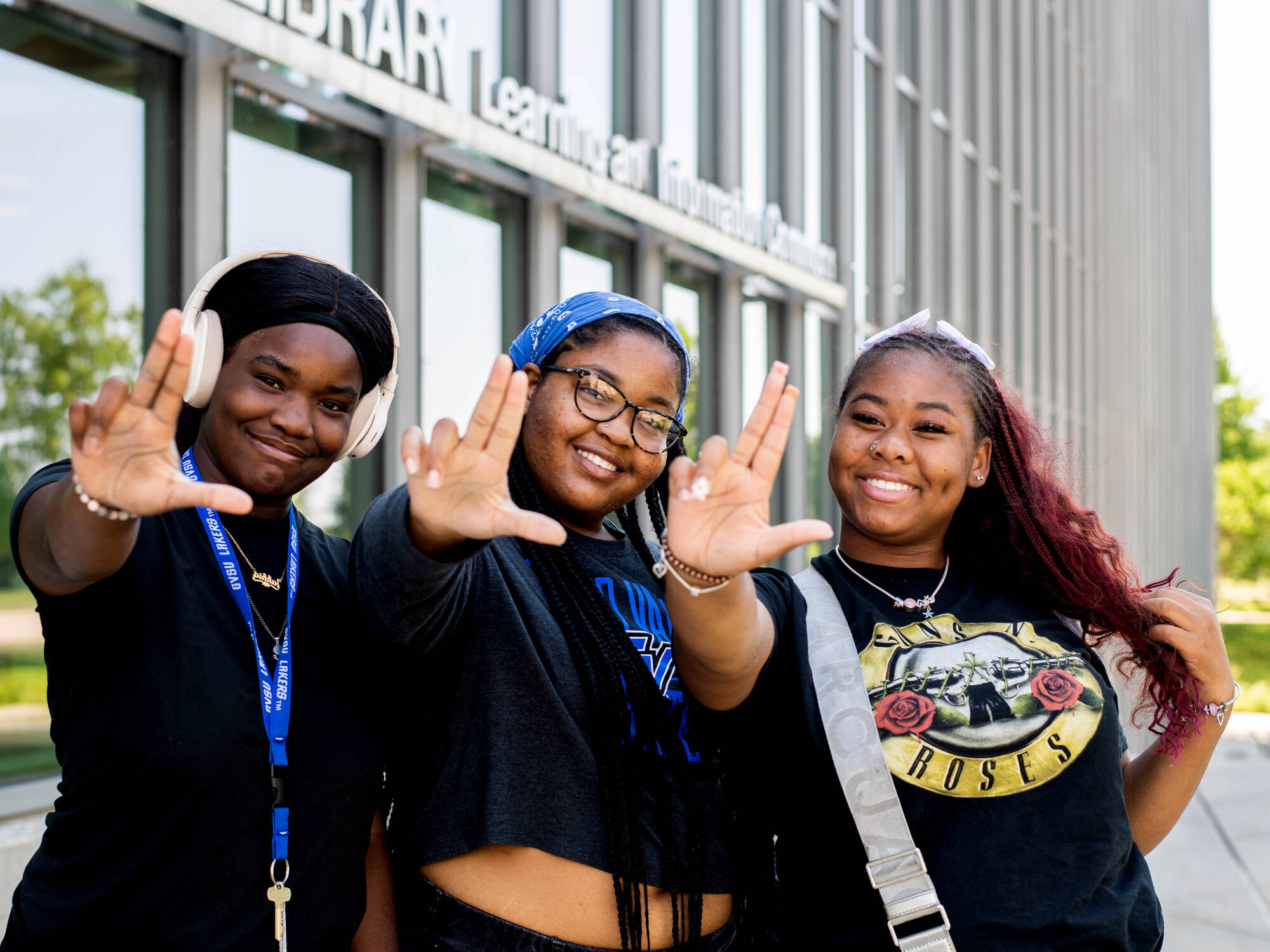 First-year students, from left, communications major Jakhia Johnson, fine arts major Ka’Maria Nathan, and art education major J’Nya Brown pose for a photo as they left their Navigating College Success class held at the Mary Idema Pew Library July 2...